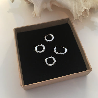Silver Huggie earrings with Black Zirconia gemstones.