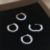 Silver Huggie earrings with Black Zirconia gemstones.
