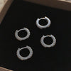 Silver Huggie earrings with clear Zirconia gemstones.