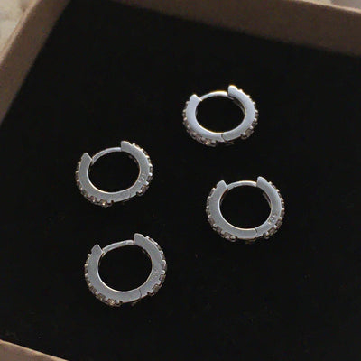 Silver Huggie earrings with clear Zirconia gemstones.