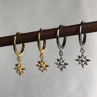 Display of Star Dangle earrings in Silver and Gold