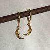 18k Gold Plated Vivid Moon Dangle earrings hanging from a wooden display